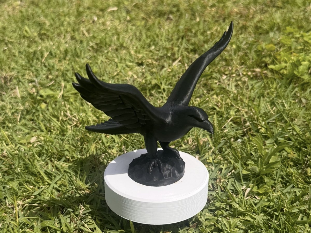 Sculpted eagle marker on a disc base, staked on a tee box