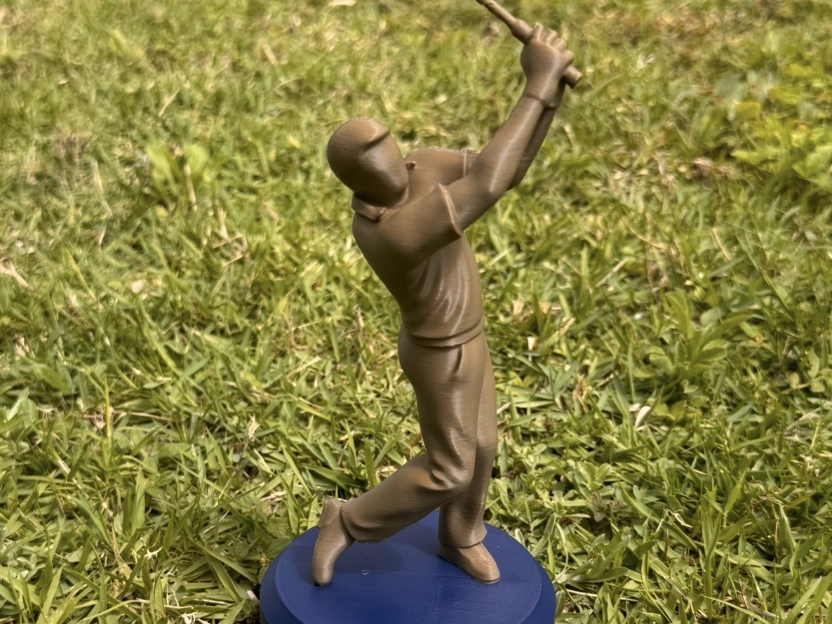 Sculpted championship golfer figure on a plinth, on a tee box